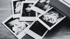 Schwarz-weiß-Fotografie unsortierter Kinderfotos – Symbolbild für verdrängte Kindheitserinnerungen und Kindheitstrauma